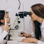 optometrist examining a child’s eyes for signs of myopia progression