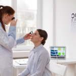 optometrist examining a patient’s eyes for signs of dry eye